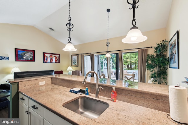 39234 Timberlake Ct Unit 9203, Bethany Beach, DE 19930 - kitchen featuring light stone counters, decorative light fixtures, a sink, and vaulted ceiling