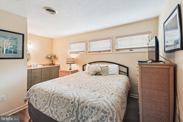 39234 Timberlake Ct Unit 9203, Bethany Beach, DE 19930 - bedroom featuring multiple windows, a textured ceiling, visible vents, and baseboards