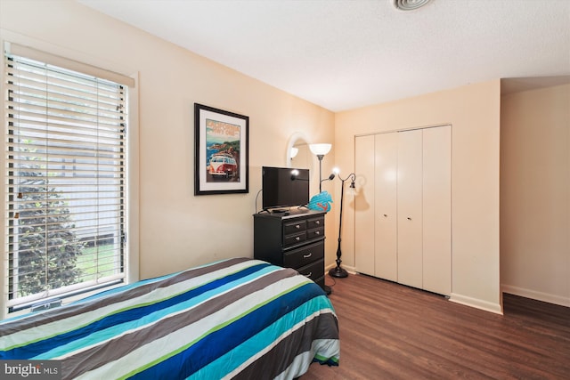 39234 Timberlake Ct Unit 9203, Bethany Beach, DE 19930 - bedroom featuring a closet, baseboards, multiple windows, and wood finished floors