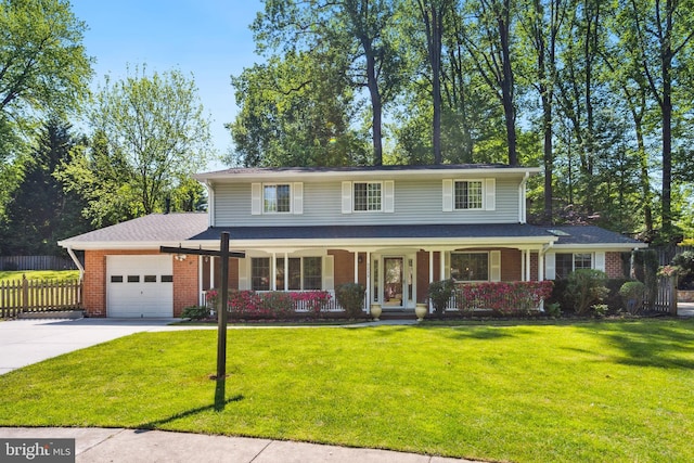traditional home with a garage, driveway, brick siding, and covered porch