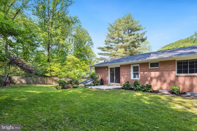 back of house featuring brick siding and a patio