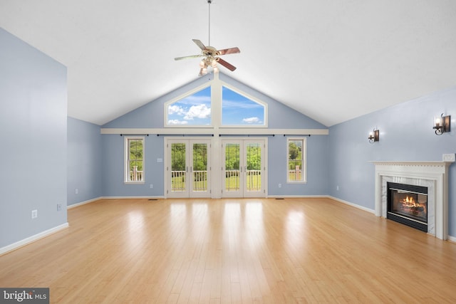 111 Fox Hill Rd, Front Royal, VA 22630 - unfurnished living room with a glass covered fireplace, ceiling fan, healthy amount of natural light, light wood-style flooring, and high vaulted ceiling