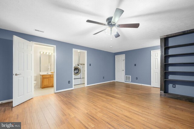 111 Fox Hill Rd, Front Royal, VA 22630 - unfurnished bedroom featuring washing machine and clothes dryer, light wood-type flooring, two closets, baseboards, and ensuite bath