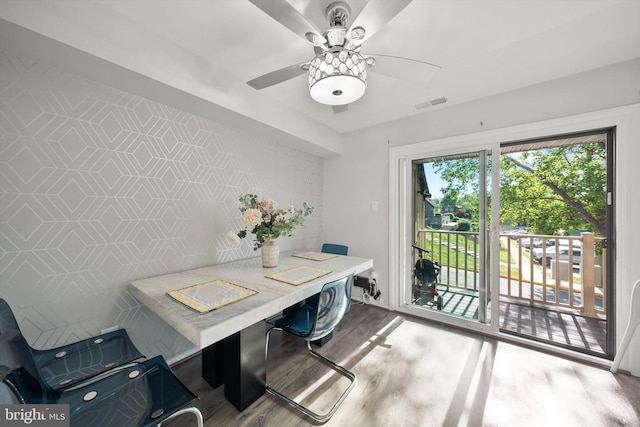dining area featuring ceiling fan, visible vents, and wood finished floors