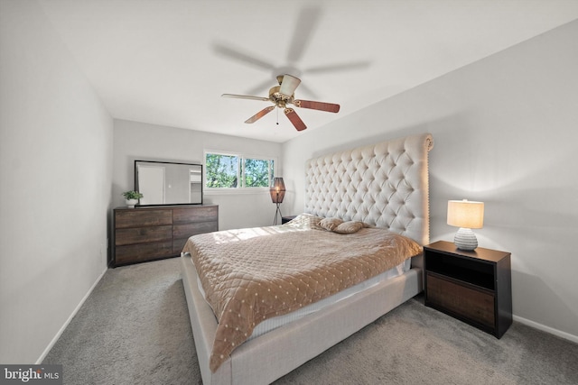 carpeted bedroom featuring baseboards and ceiling fan