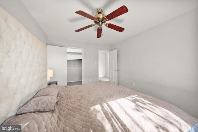 bedroom featuring a closet, a ceiling fan, and a spacious closet