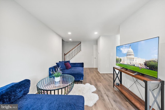living room featuring recessed lighting, stairs, and wood finished floors