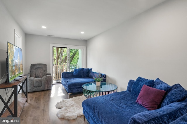 bedroom with recessed lighting, visible vents, access to exterior, and wood finished floors
