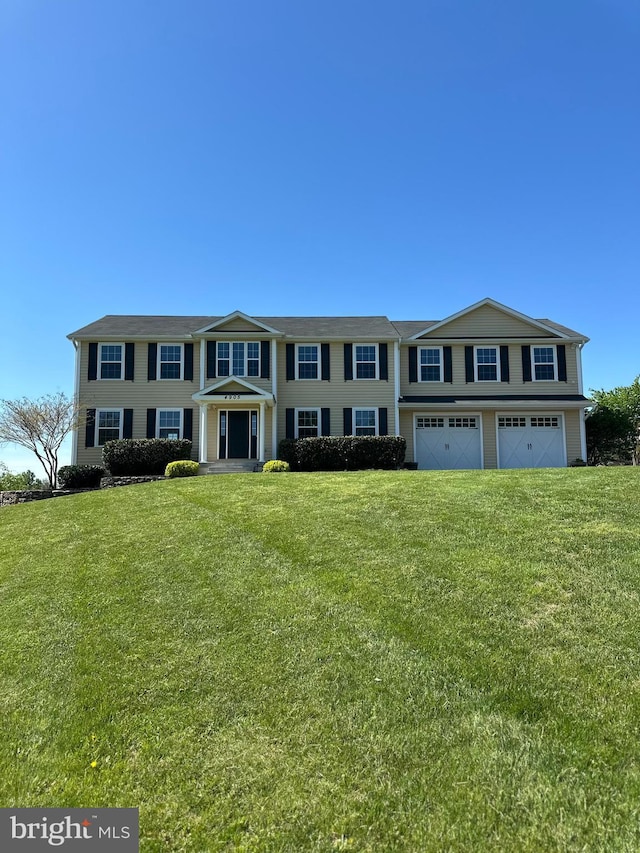 view of front of home featuring a garage and a front lawn