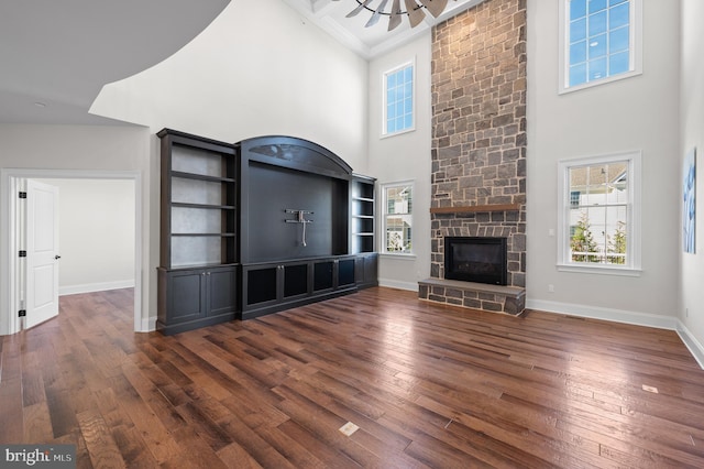 3703 Biddle Ln, Newtown Square, PA 19073 - unfurnished living room featuring baseboards, a towering ceiling, a healthy amount of sunlight, and dark wood-style floors