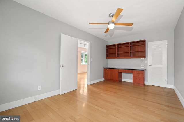 1301 N Ode St Unit 135, Arlington, VA 22209 - unfurnished living room featuring a ceiling fan, light wood-style flooring, and baseboards