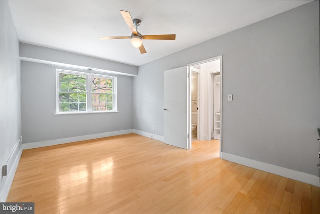 1301 N Ode St Unit 135, Arlington, VA 22209 - spare room featuring ceiling fan, light wood-type flooring, and baseboards