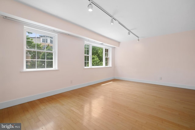 1301 N Ode St Unit 135, Arlington, VA 22209 - spare room with track lighting, light wood-style flooring, and baseboards