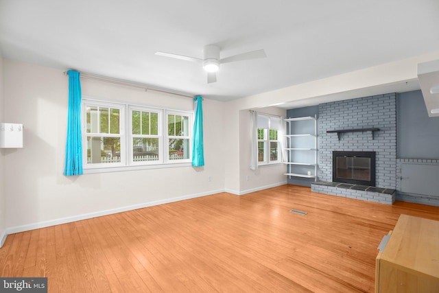 1417 Franklin St, Fredericksburg, VA 22401 - unfurnished living room with baseboards, a ceiling fan, wood finished floors, and a brick fireplace