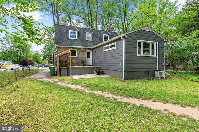 6248 Woodcrest Ave, Baltimore, MD 21209 - rear view of house with a lawn, fence, a chimney, and stone siding