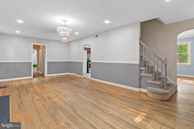 6248 Woodcrest Ave, Baltimore, MD 21209 - spare room featuring arched walkways, recessed lighting, wood finished floors, and visible vents