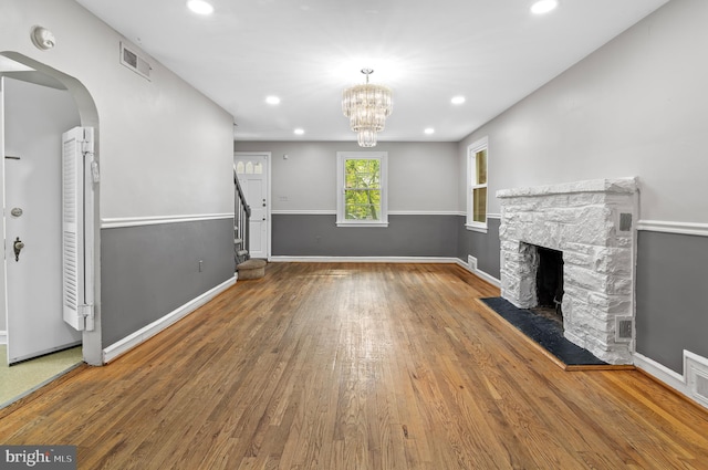 6248 Woodcrest Ave, Baltimore, MD 21209 - unfurnished living room featuring recessed lighting, visible vents, a stone fireplace, and wood finished floors