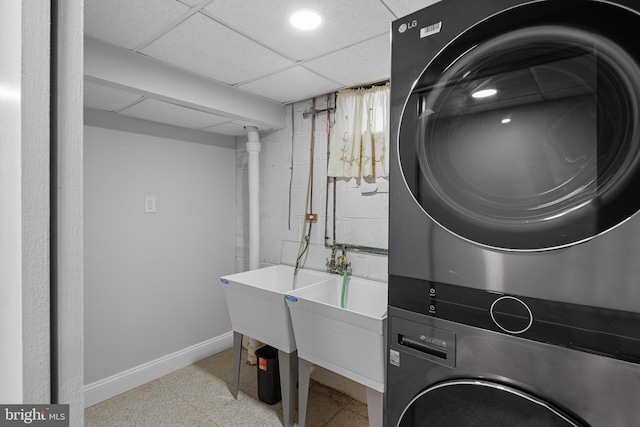 310 18th Ave, Baltimore, MD 21225 - laundry area featuring laundry area, stacked washer and clothes dryer, baseboards, and concrete block wall