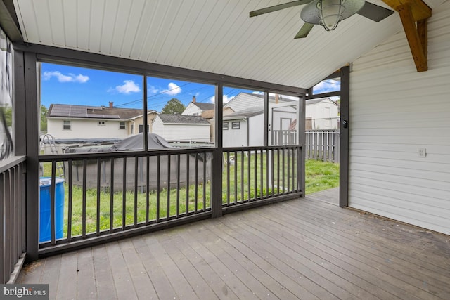 310 18th Ave, Baltimore, MD 21225 - unfurnished sunroom with beam ceiling, a ceiling fan, and a residential view