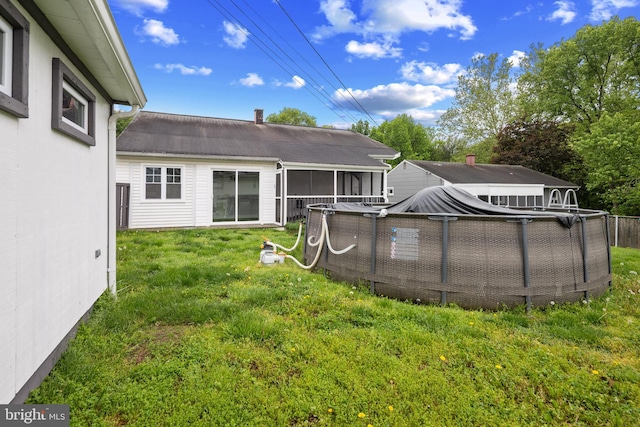 310 18th Ave, Baltimore, MD 21225 - rear view of property featuring a sunroom, a yard, and an outdoor pool
