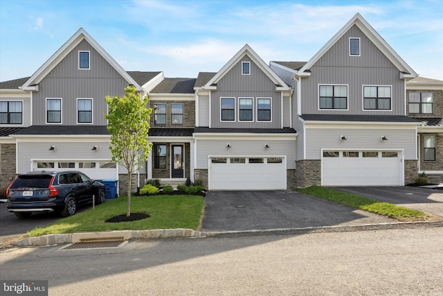 9 Mill Creek Dr, Doylestown, PA 18901 - view of property with board and batten siding, driveway, and stone siding