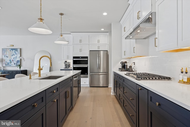 9 Mill Creek Dr, Doylestown, PA 18901 - kitchen with appliances with stainless steel finishes, a sink, light countertops, white cabinets, and under cabinet range hood
