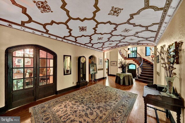 218 Parkside Ave, Trenton, NJ 08618 - foyer featuring arched walkways, hardwood / wood-style flooring, stairs, baseboards, and ornamental molding
