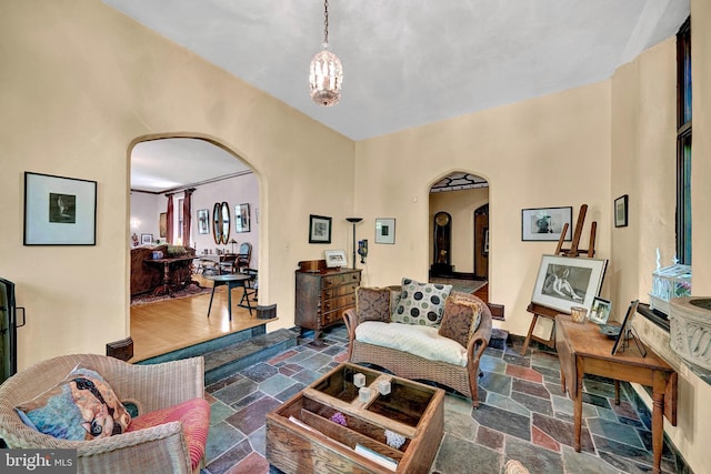 218 Parkside Ave, Trenton, NJ 08618 - living room with arched walkways, stone tile floors, and a chandelier