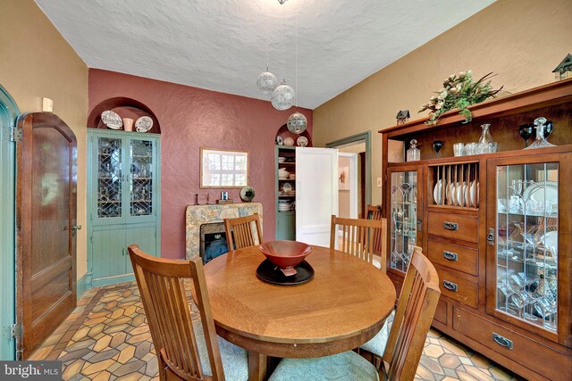 218 Parkside Ave, Trenton, NJ 08618 - dining space with a textured ceiling, a textured wall, and light stone finish flooring