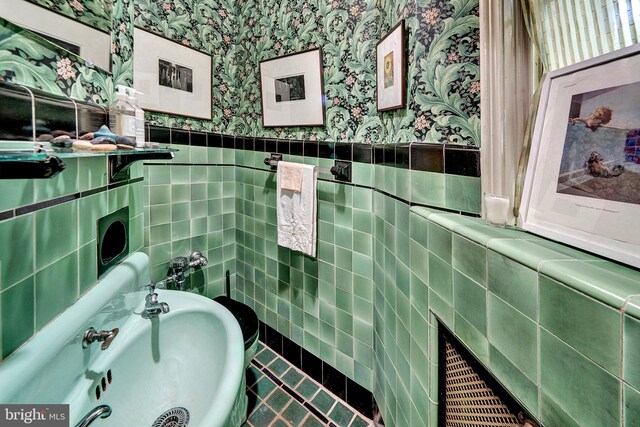 218 Parkside Ave, Trenton, NJ 08618 - bathroom with wallpapered walls, tile walls, wainscoting, and a sink