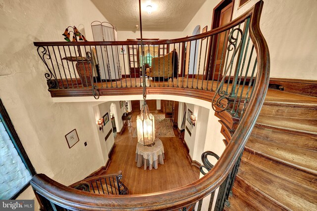 218 Parkside Ave, Trenton, NJ 08618 - staircase featuring a textured ceiling, wood finished floors, and arched walkways