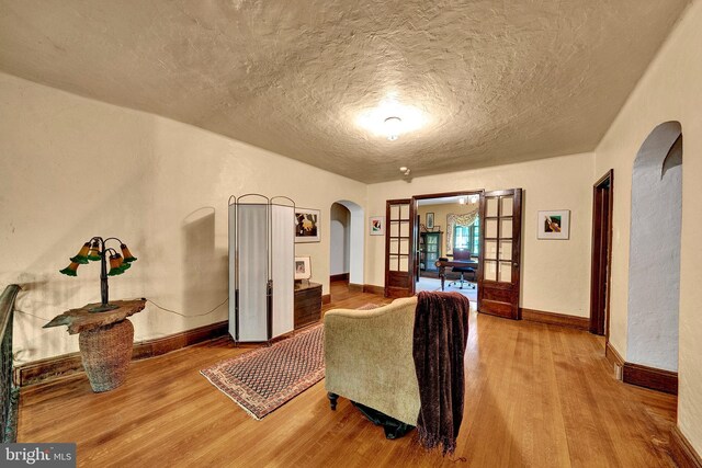 218 Parkside Ave, Trenton, NJ 08618 - living room with arched walkways, wood finished floors, a textured ceiling, and baseboards