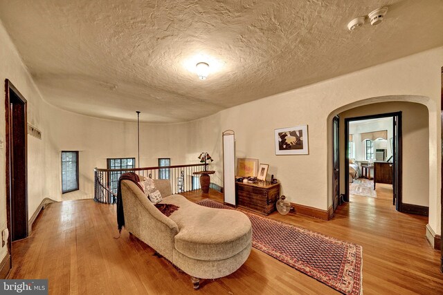 218 Parkside Ave, Trenton, NJ 08618 - living area featuring arched walkways, wood finished floors, a textured ceiling, and baseboards