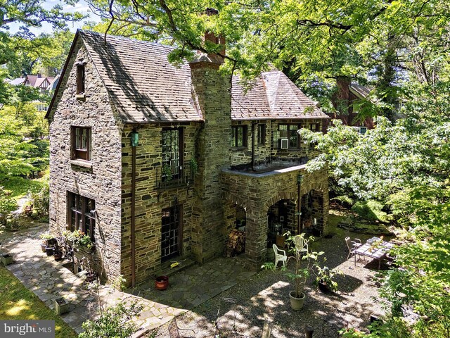 218 Parkside Ave, Trenton, NJ 08618 - view of side of home featuring a patio area, stone siding, and a chimney