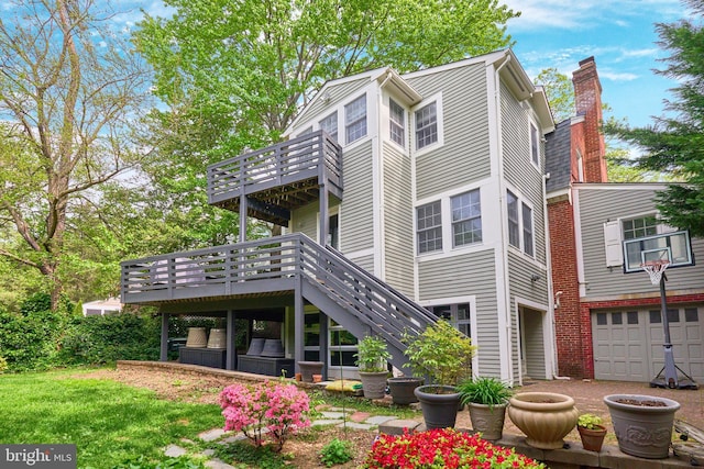 rear view of house with a chimney, stairs, and a wooden deck