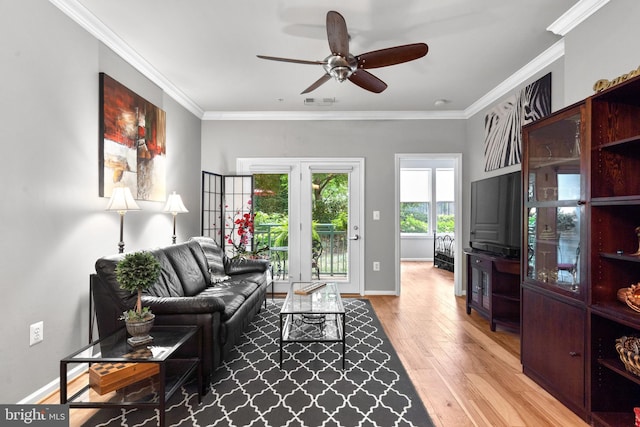 living room with baseboards, a ceiling fan, wood finished floors, and ornamental molding