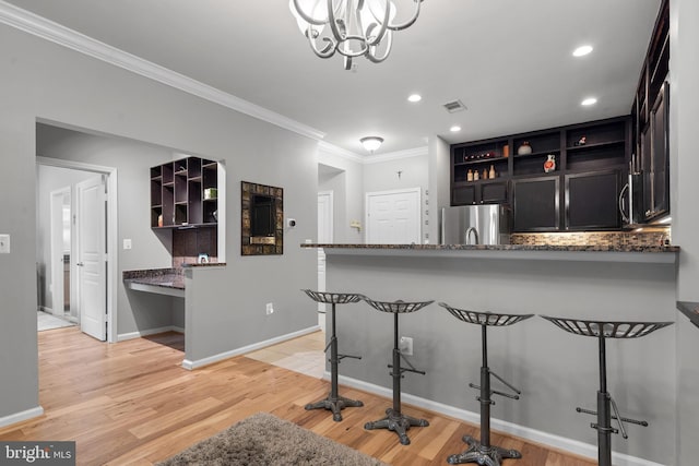 kitchen with freestanding refrigerator, open shelves, visible vents, and crown molding