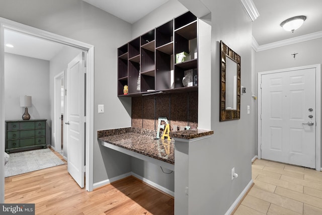 interior space with crown molding, baseboards, and light wood-type flooring