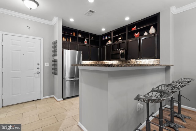 kitchen featuring visible vents, open shelves, ornamental molding, and stainless steel appliances