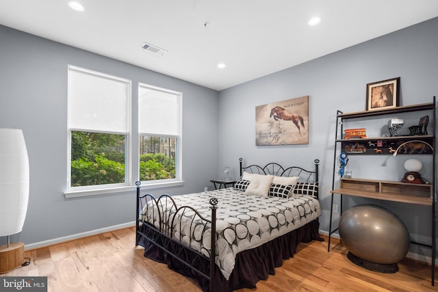 bedroom with visible vents, recessed lighting, baseboards, and wood finished floors