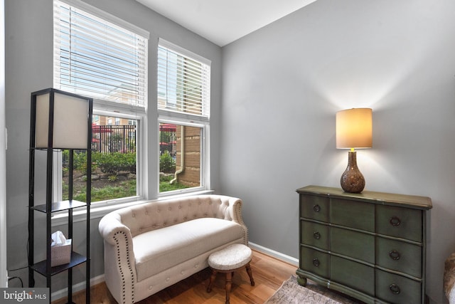 sitting room featuring baseboards and wood finished floors