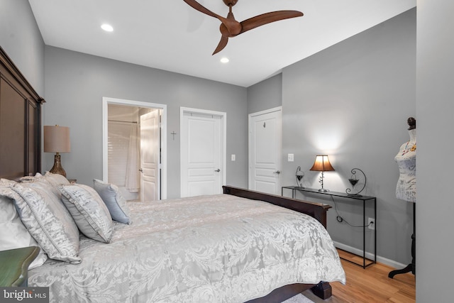 bedroom with baseboards, ceiling fan, recessed lighting, connected bathroom, and light wood finished floors