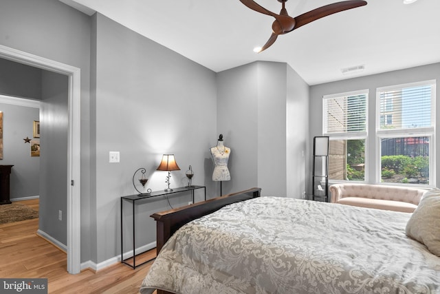 bedroom with light wood-type flooring, baseboards, and visible vents
