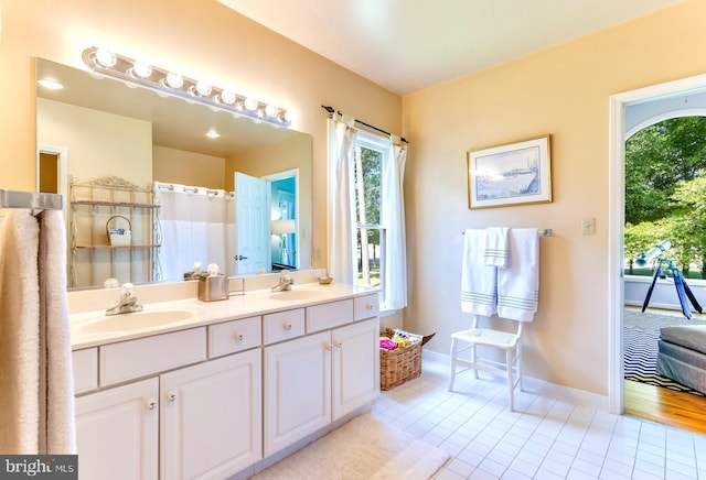 117 Kings Creek Cir, Rehoboth Beach, DE 19971 - bathroom with double vanity, tile patterned flooring, and baseboards
