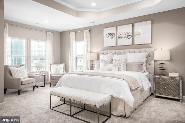 carpeted bedroom with visible vents, crown molding, baseboards, a tray ceiling, and recessed lighting