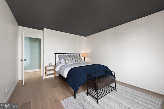 bedroom with wood finished floors and baseboards