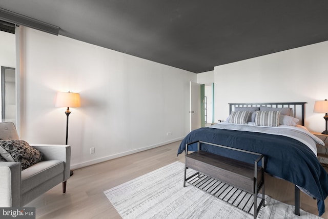 bedroom with wood finished floors and baseboards