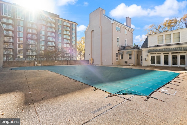 community pool with a patio area