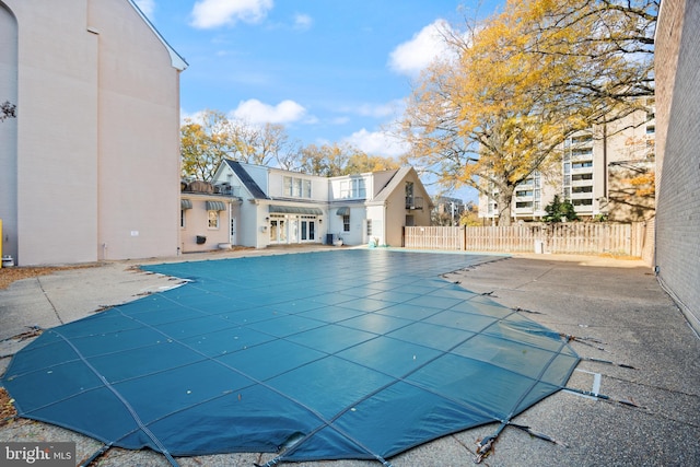view of swimming pool with fence and a patio area