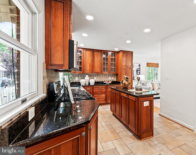 708 W Timber Branch Pkwy, Alexandria, VA 22302 - kitchen featuring backsplash, brown cabinetry, recessed lighting, stainless steel microwave, and glass insert cabinets